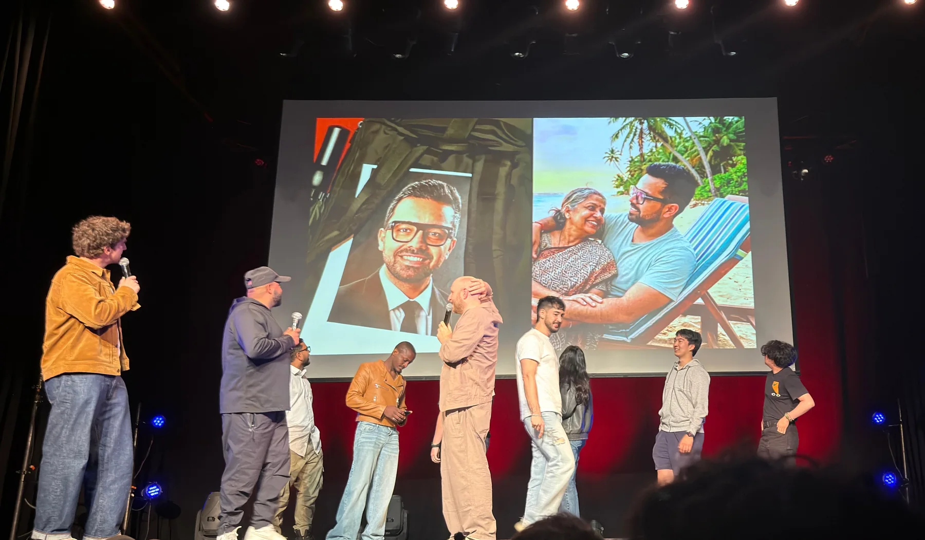 People on stage at Tech Roast Show with Parul’s printed portrait and another photo projected behind them.