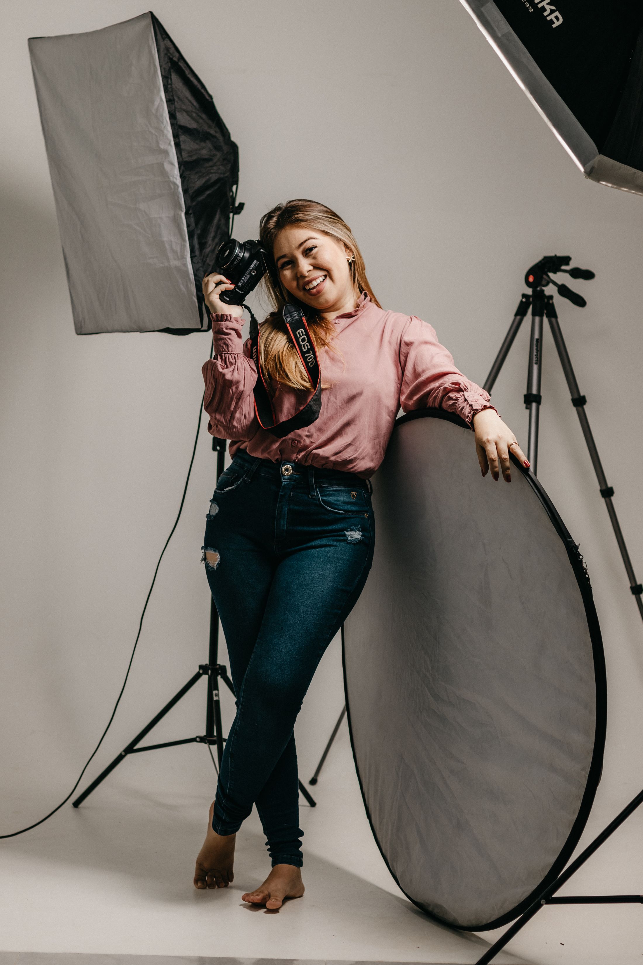 A photographer with her camera and lighting equipment