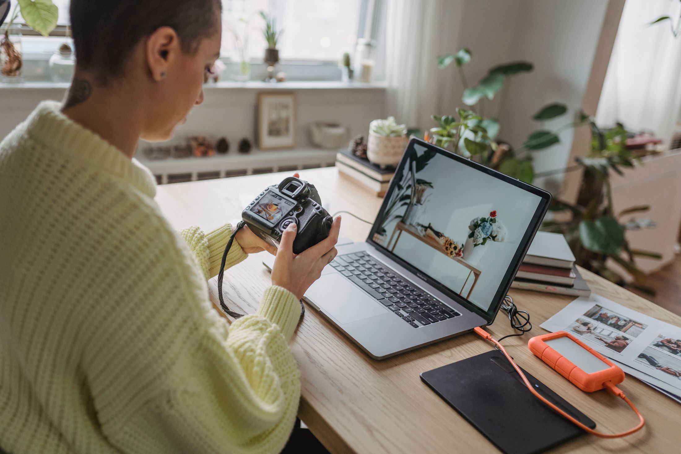 A photographer editing camera photos