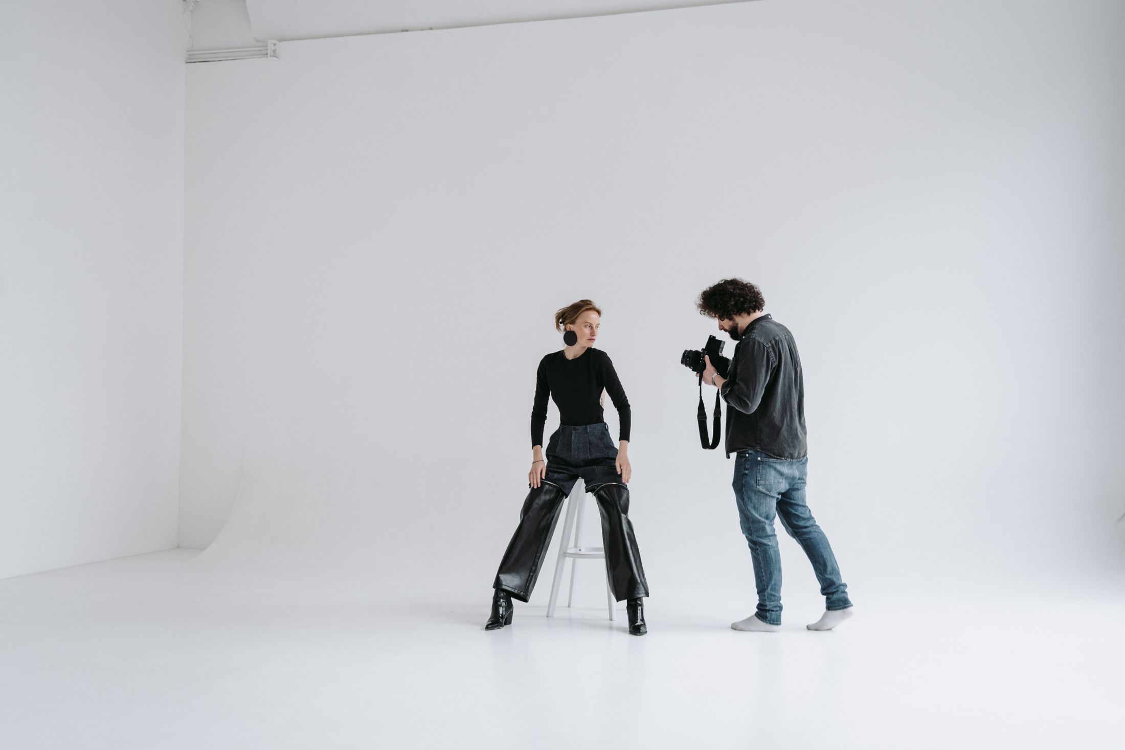 Behind the shoot: a photographer and model working in a bright studio