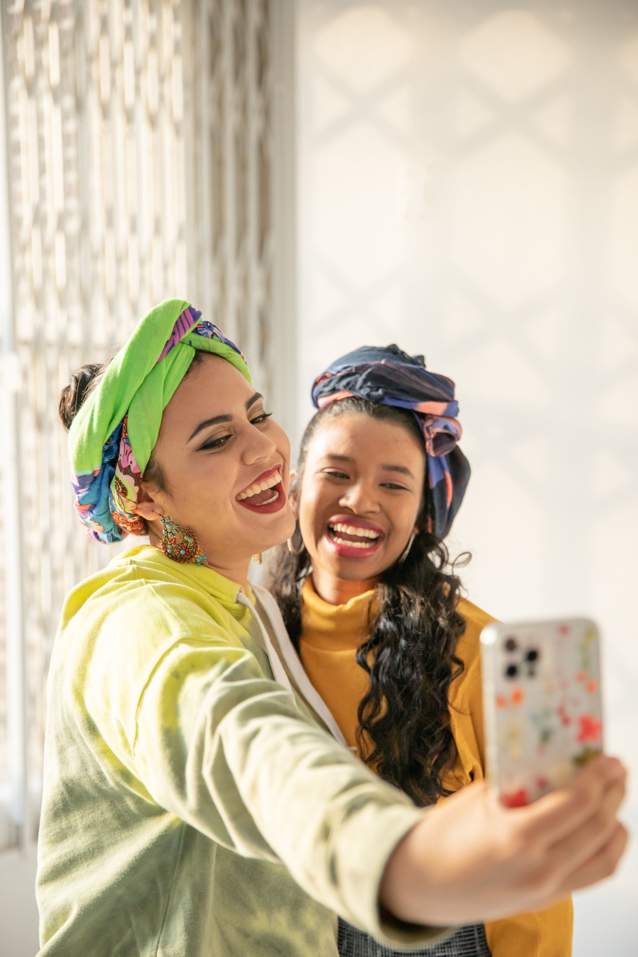 Two friends laughing as they create a selfie