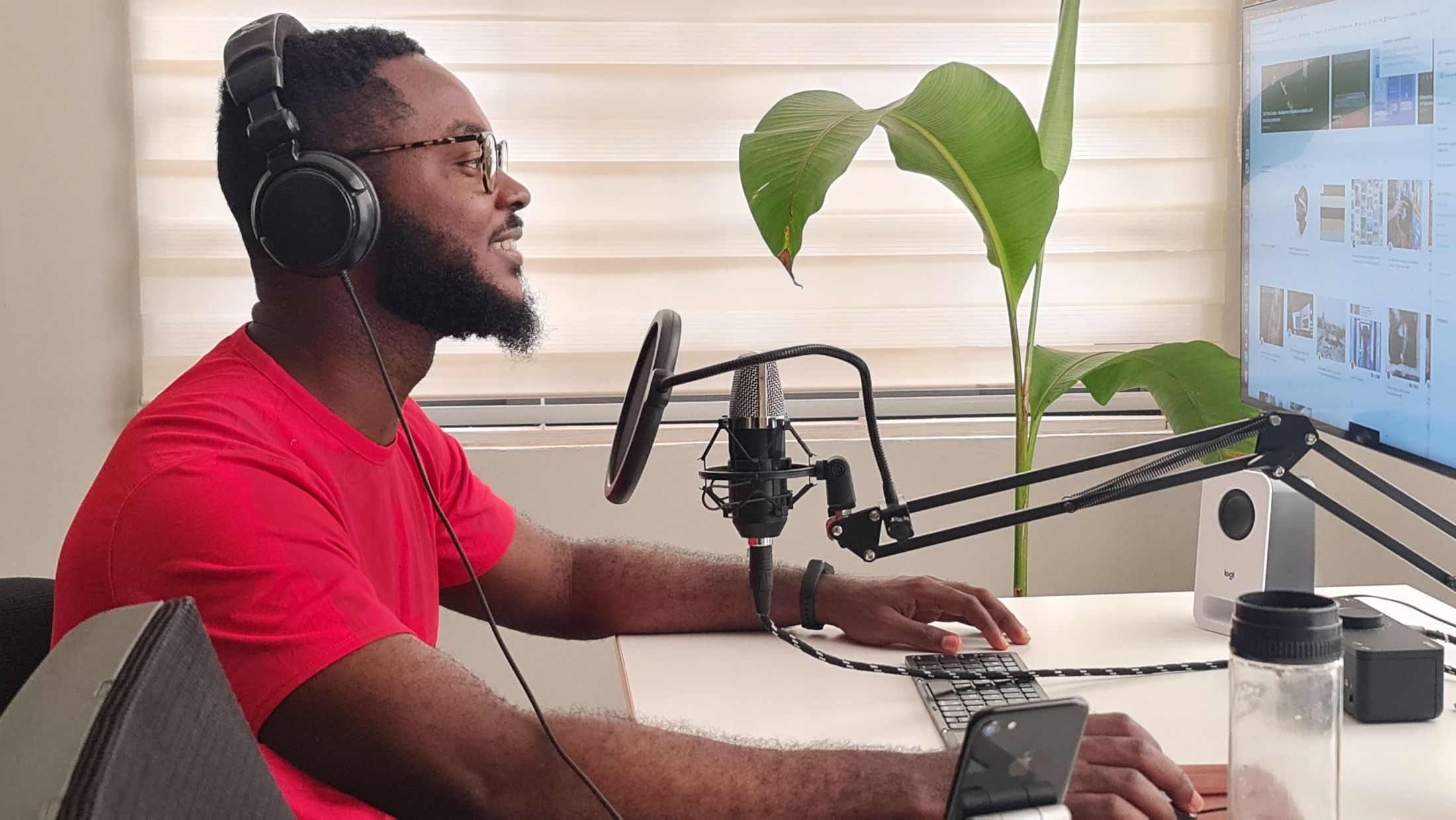 A man recording a podcast at his desk